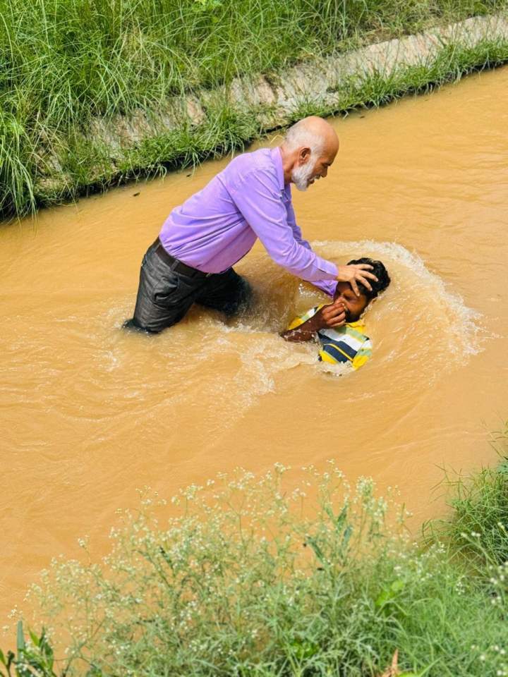 Pastor Singh baptizes a new believer. His congregation is three times larger than it was when he and his wife were beaten for their faith in Jesus.